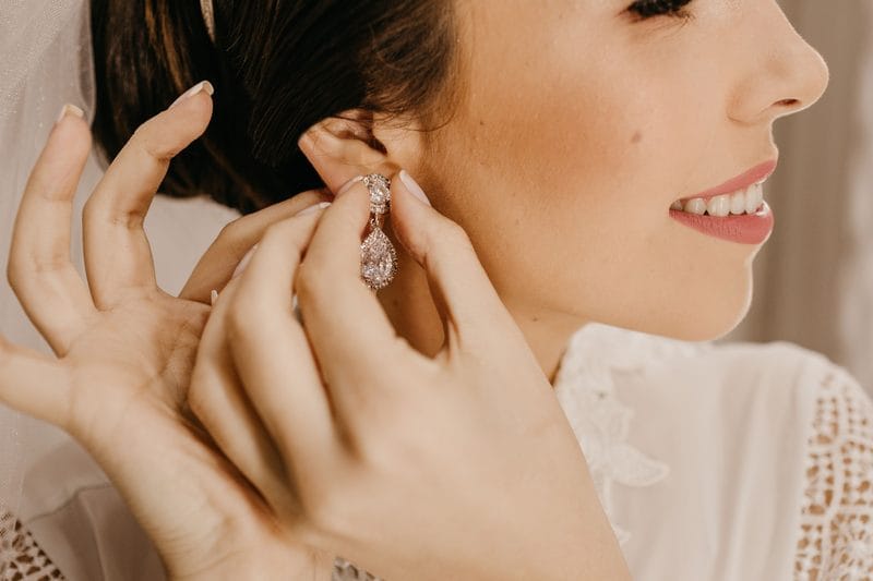 A bride wearing fine diamond earrings