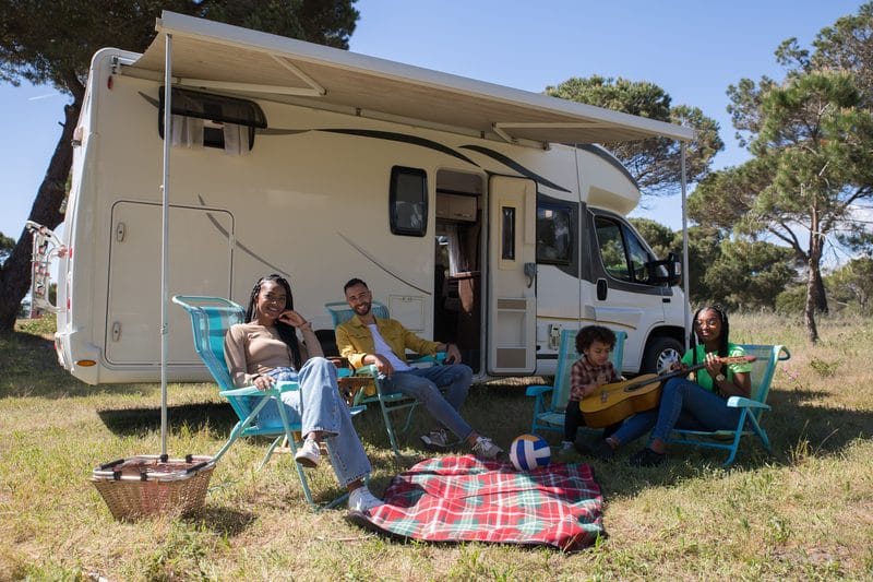 A family relaxing at their RV campsite